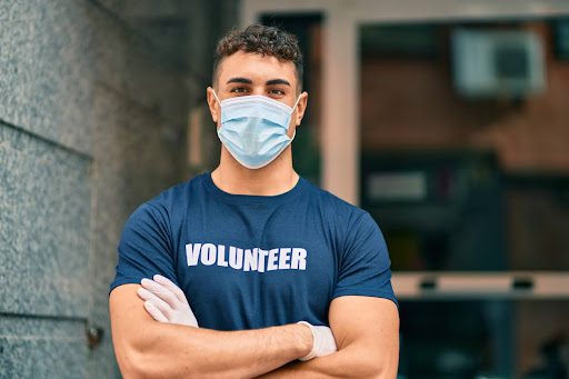 unnamed-10 Alt Text: A young medical volunteer looks into camera